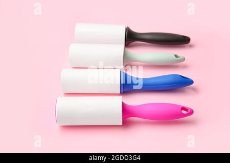 Different lint rollers on color background Stock Photo