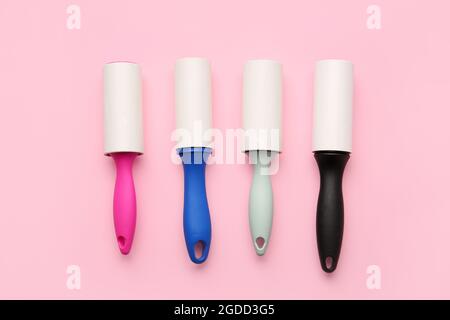 Different lint rollers on color background Stock Photo