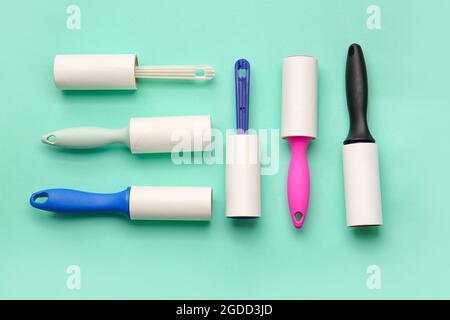 Different lint rollers on color background Stock Photo