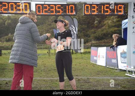 REEFTON, NEW ZEALAND, AUGUST 7, 2021; Competitor Caitlin Ryan receives her medal for completing the 10km section of the Red Cross Resilience Ultra end Stock Photo