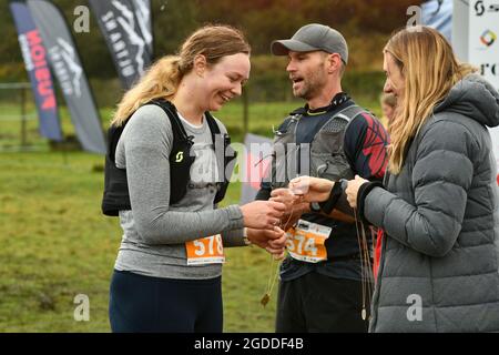 REEFTON, NEW ZEALAND, AUGUST 7, 2021; Competitor Colette Humphries receives her medal for completing the 10km section of the Red Cross Resilience Ultr Stock Photo