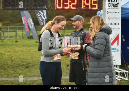 REEFTON, NEW ZEALAND, AUGUST 7, 2021; Competitor Colette Humphries receives her medal for completing the 10km section of the Red Cross Resilience Ultr Stock Photo