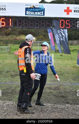 REEFTON, NEW ZEALAND, AUGUST 7, 2021; Competitor Naomi Brand meets race organiser after completing the 49km section of the Red Cross Resilience Ultra Stock Photo