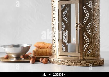 Muslim lantern with Turkish sweets on light background Stock Photo