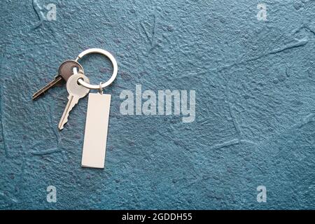 Keys with stylish keychain on dark background Stock Photo