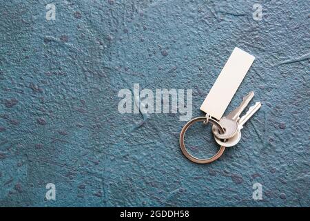 Keys with stylish keychain on dark background Stock Photo