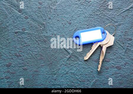 Plastic tag with keys on dark background Stock Photo