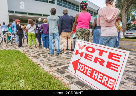 Miami Florida,Hollywood City Hall early voting presidential election,line queue precinct Black men women sign vote here,outside exterior, Stock Photo