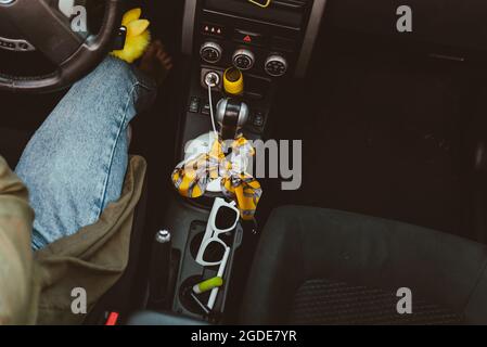 inside of the car with little women things sunglasses lipstick phone at phone holder. car travel concept Stock Photo