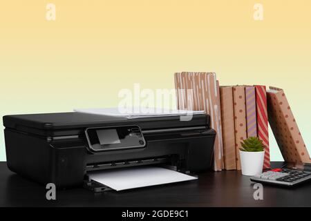 Compact home laser printer against yellow background Stock Photo