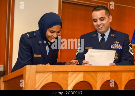 U.S. Air Force Chaplain Candidate 2nd Lt. Saleha Jabeen, and U.S. Air Force Master Sgt. Alexander James, recruiter, sign recruitment paperwork after a commissioning ceremony Dec. 18, 2019, at the Catholic Theological Union, Chicago, Illinois. Jabeen is scheduled to continue training and be assigned to a unit once she has completed all initial training requirements. (U.S. Air Force photo/ Tech. Sgt. Armando A. Schwier-Morales) Stock Photo