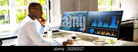 African Advisor Using KPI Dashboard With Financial Analytics Graphs Stock Photo