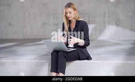 Blond businesswoman making video call Stock Photo