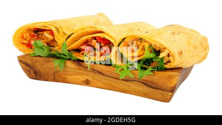 Group of filled soft tortilla wraps in a olive wood serving bowl isolated on a white background Stock Photo