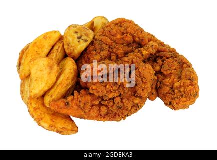 Fried spicy breadcrumb covered chicken fillets and potato wedges meal isolated on a white background Stock Photo