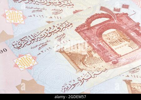 Syrian pound or Lira banknotes. Money of the Arabic country. Close up detailed money background wallpaper. Banknotes of the battered by the war countr Stock Photo