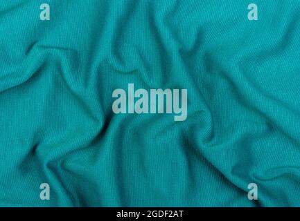 Turquoise jersey fabric matte texture top view. Blue knitwear background. Fashion color trendy clothes. Website backdrop text sign design. Abstract aq Stock Photo