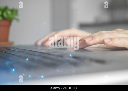 Female hands on laptop computer. Woman working remotely at home. Concept of networking and remote freelance work, global business network Stock Photo