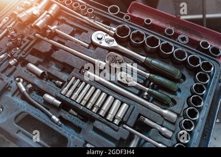 Above view of used greasy old dirty car repair mechanic hand tool set kit vehicle repair and maintencae service. Hardware toolkit with many different Stock Photo