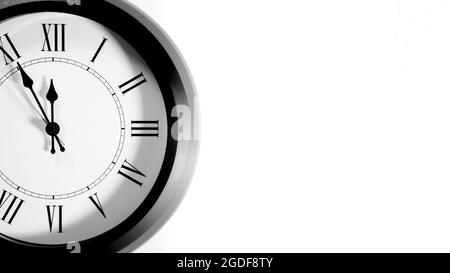 It is five to twelve, the clock is ticking. Grey Watch shows the time 5 before 12. Close up to a wall clock, with five minutes to twelve o'clock. Time Stock Photo