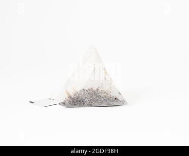 triangular disposable tea bag on a rope, white background Stock Photo