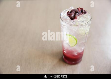 Berry cocktail with lime on wood background Stock Photo