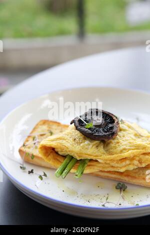 Scrambled eggs with bread asparagus and mushroom in close up Stock Photo