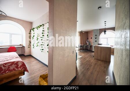 Stylish modern interior kitchen studio and bedroom with trendy furniture. Concept of modern furniture and modern interior in light colors. Stock Photo