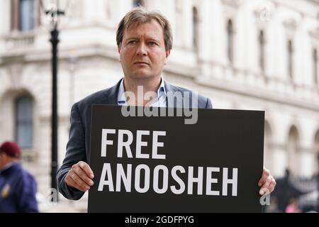 Richard Ratcliffe joins the family of Anoosheh Ashoori (not pictured), a British man who has been jailed in Iran, to stage an 'empty chair' protest opposite Downing Street, London, marking the 4th anniversary of his imprisonment. Picture date: Friday August 13, 2021. Stock Photo