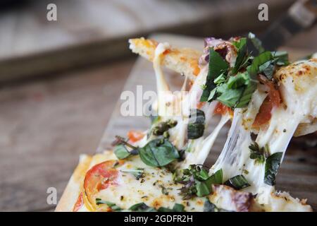 pizza with seafood and tomatoes on a wooden table , italian food Stock Photo
