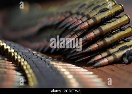 Linked belts of 7.62mm ammunition are seen on a table as paratroopers assigned to the 6th Brigade Engineer Battalion (Airborne), 4th Infantry Brigade Combat Team (Airborne), 25th Infantry Division, U.S. Army Alaska, fire M240B machine guns while conducting live-fire training at Statler range on Joint Base Elmendorf-Richardson, Alaska, Aug. 3, 2021. The Soldiers practiced identifying, and engaging targets at varying distances to solidify their proficiency with the weapons in a support by fire roll. (U.S. Air Force photo/Justin Connaher) Stock Photo