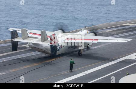 210811-N-NY362-1216 ARABIAN SEA (Aug. 11, 2021) – A C-2A Greyhound fleet logistics transport plane, attached to the “Providers” of Fleet Logistics Support Squadron (VRC) 30, Det. 5, prepares to taxi on the flight deck of aircraft carrier USS Ronald Reagan (CVN 76) in the Arabian Sea, Aug. 11. Ronald Reagan is the flagship for Carrier Strike Group 5 and is deployed to the U.S. 5th Fleet area of operations in support of naval operations to ensure maritime stability and security in the Central Region, connecting the Mediterranean and the Pacific through the western Indian Ocean and three strategi Stock Photo