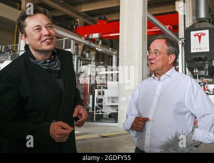 Brandenburg, Germany. 13 August 2021:: Elon Musk (l), Tesla CEO, and Armin Laschet, CDU Federal Chairman and Minister President of North Rhine-Westphalia, visit the future foundry at the Tesla Gigafactory plant. The first vehicles are due to roll off the production line in Grünheide near Berlin from the end of 2021. The US company plans to build around 500,000 units of the compact Model 3 and Model Y series here each year. Credit: dpa picture alliance/Alamy Live News Stock Photo