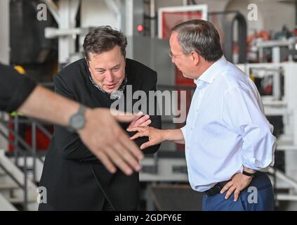 Brandenburg, Germany. 13 August 2021:: Elon Musk (l), Tesla CEO, and Armin Laschet, CDU Federal Chairman and Minister President of North Rhine-Westphalia, talk during a tour of the Tesla Gigafactory's future foundry. The first vehicles are scheduled to roll off the production line in Grünheide near Berlin from the end of 2021. The US company plans to build around 500,000 units of the compact Model 3 and Model Y series here each year. Credit: dpa picture alliance/Alamy Live News Stock Photo