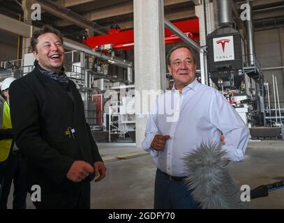 Brandenburg, Germany. 13 August 2021:: Elon Musk (l), Tesla CEO, and Armin Laschet, CDU Federal Chairman and Minister President of North Rhine-Westphalia, visit the future foundry at the Tesla Gigafactory plant. The first vehicles are due to roll off the production line in Grünheide near Berlin from the end of 2021. The US company plans to build around 500,000 units of the compact Model 3 and Model Y series here each year. Credit: dpa picture alliance/Alamy Live News Stock Photo