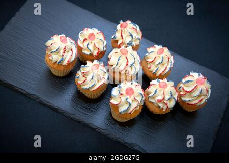 Small and festive celebration cupcakes in English colours by pastry chef Joanne Todd Stock Photo