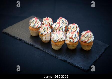 Small and festive celebration cupcakes in English colours by pastry chef Joanne Todd Stock Photo