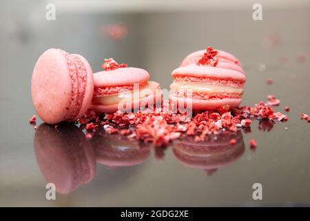 Pink macarons --- Macaronor French macaroon is a sweet meringue-based confection made with egg white, icing sugar, granulated sugar, almond meal, and Stock Photo