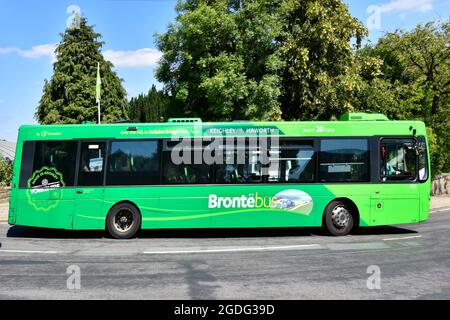 Side view graphics on Green single deck Bronte Bus operated by Transdev transport bottom end of Main Street hill in Haworth West Yorkshire, England UK Stock Photo