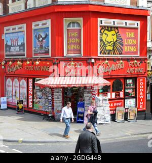 Street scene colorful Crispins Food Wine News & Bakery Hall corner shop theatreland advertising in Shaftsbury Avenue Soho West End London England UK Stock Photo