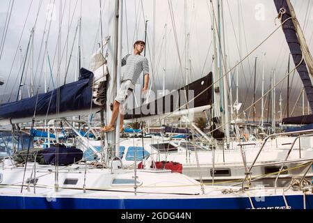 Man on sailboat, Cape Town, Western Cape, South Africa Stock Photo