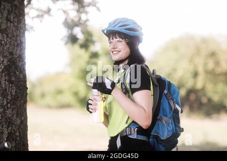 Biker stopping in park Stock Photo