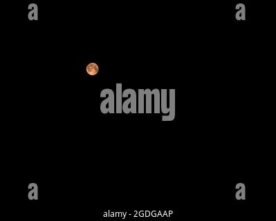 Blood Moon - Full Moon after the lunar eclipse on July 27, 2018 on a black background. Stock Photo