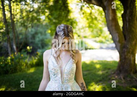 Portrait of attractive young woman looking down in nature. Stock Photo