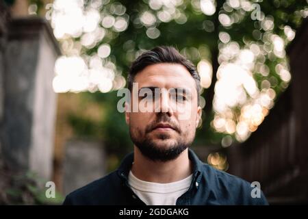 Portrait of serious confident man in city Stock Photo