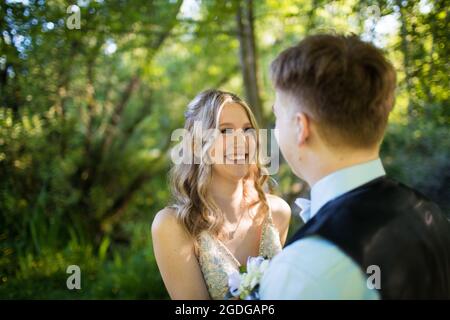 Eager attractive young woman smiles at her partner in anticipation Stock Photo
