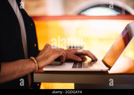 Man using laptop computer at cafe Stock Photo