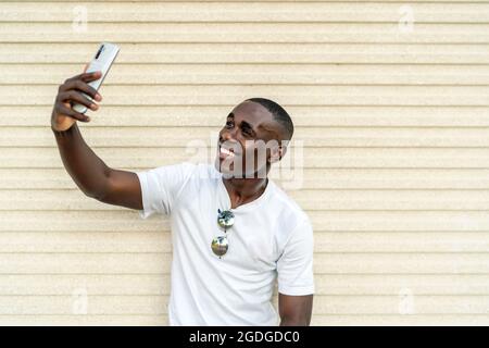 young african man taking a selfie from his smartphone Stock Photo