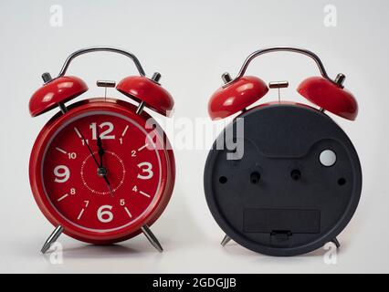 Red alarm clock seen from front and back isolated white background Stock Photo