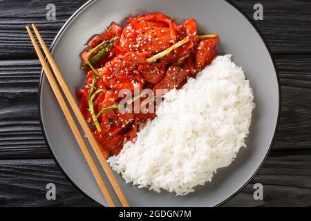 Jeyuk Bokkeum Traditional Pork Dish From South Korea close-up in a plate on the table. Horizontal top view from above Stock Photo